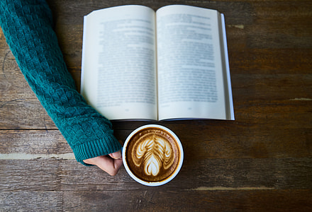 white book on brown wooden table thumbnail
