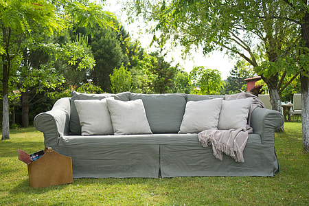 grey sofa with four white throw pillows thumbnail