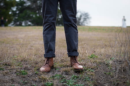 person wearing jeans and boots standing on ground thumbnail