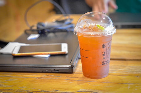 Plastic cup of tea on a table thumbnail