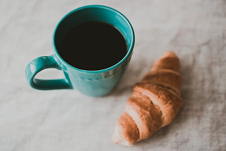 Teal Ceramic Mug Filled With Coffee Near Baked Bread thumbnail