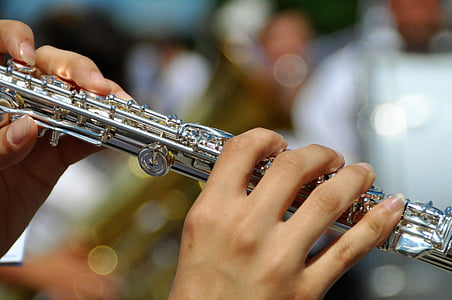 person playing silver flute thumbnail