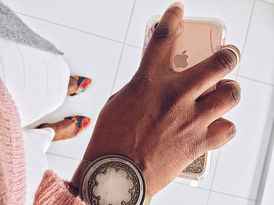 person holding rose gold iPhone 7 with cased thumbnail