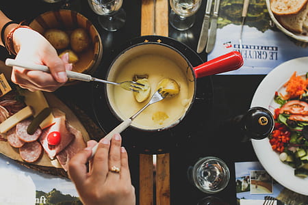 two person folding fork dipping in sauce pot thumbnail