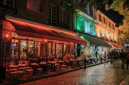 group of people sitting under awning thumbnail