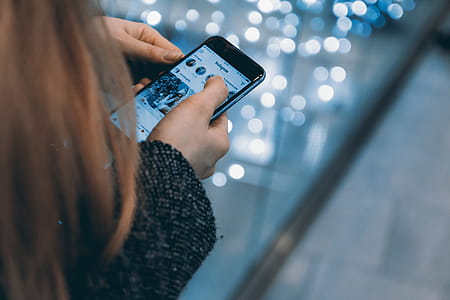 Young girl uses smartphone with Instagram app thumbnail