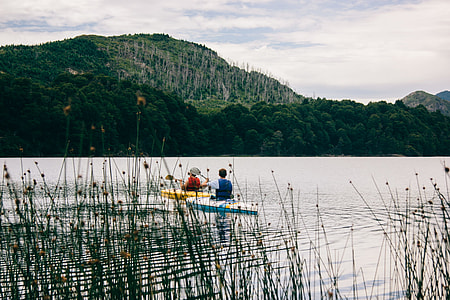 two person using kayaks on body of water during daytime thumbnail
