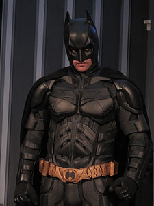Batman statue near gray and black wall thumbnail