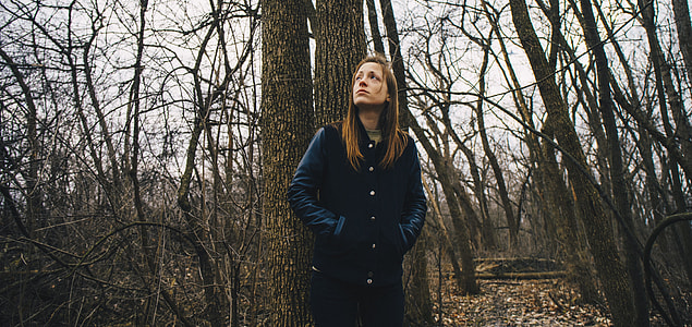 Woman in black button-up jacket and blue jeans during cloudy day thumbnail
