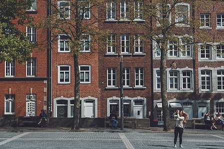 woman standing near concrete building during daytime thumbnail
