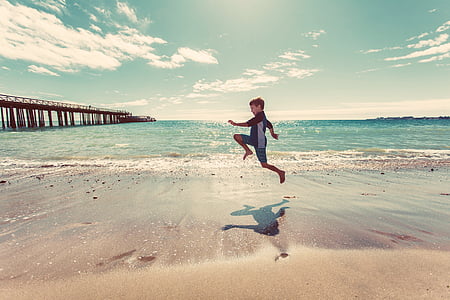 boy near body of water during daytime thumbnail