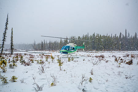 green and white helicopter on snow thumbnail