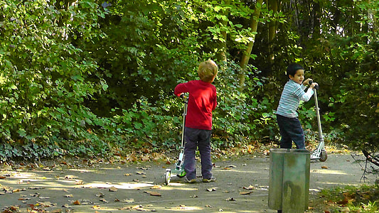 boys playing silver kick scooters thumbnail