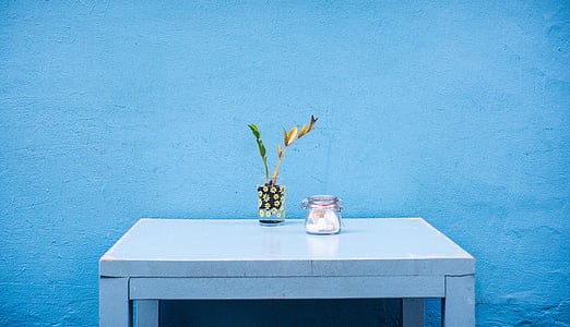 glass mason jar placed on rectangular white wooden desk thumbnail