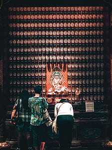 three women standing in front Hindu God thumbnail
