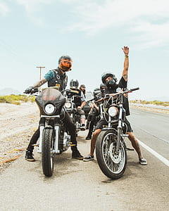 group of people riding motorcycle in front of black Jeep SUV thumbnail