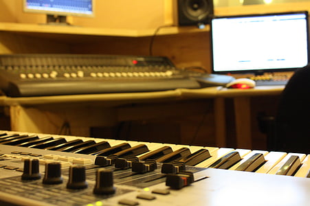 gray electric keyboard near black audio mixer thumbnail