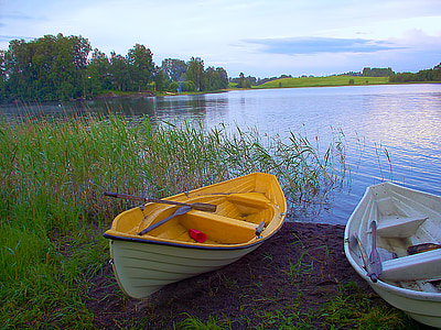 canoe beside green grass near body of water thumbnail
