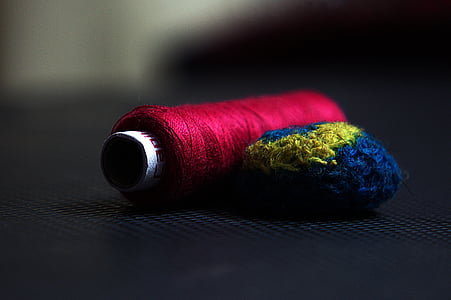 selective focus photography of red thread thumbnail