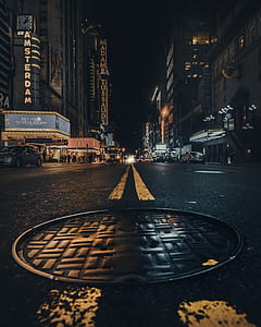 low angle photo of road between buildings at nighttime thumbnail