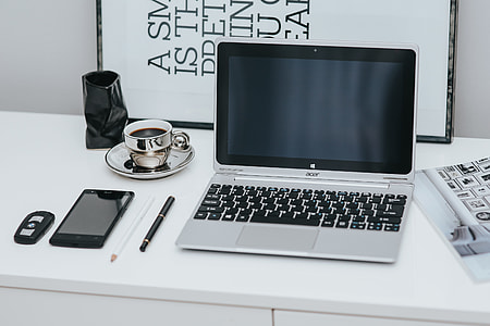 Laptop computer on white desk thumbnail
