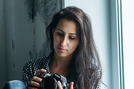Woman Holding Nikon Dslr Camera thumbnail