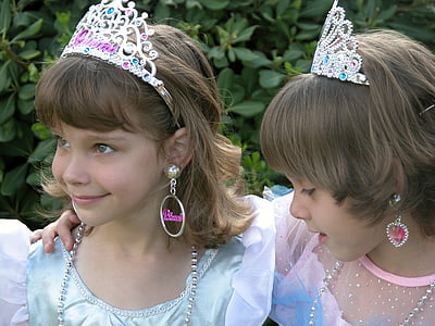 two smiling girl's wearing tiara thumbnail