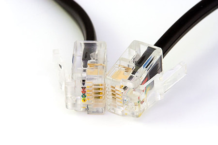 close up photo of RJ45 cable and UTP cable on white surface thumbnail