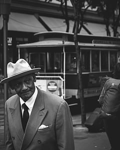 smiling man grayscale photography thumbnail