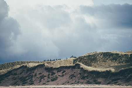 brown hill on cloudy day thumbnail