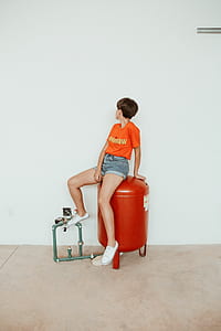 woman sitting on red air gas tank thumbnail