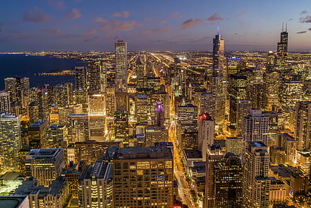 photo of city near body of water during night time thumbnail
