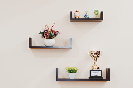 Brown Wooden Floating Shelves Mounted on Beige Painted Wall thumbnail