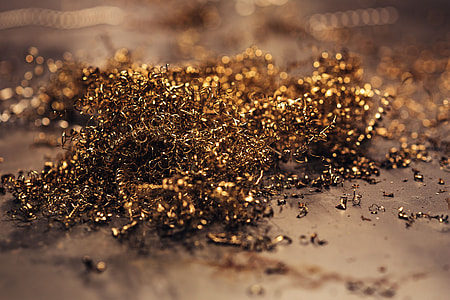 Close-ups of golden metal shavings on a table thumbnail
