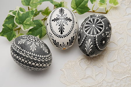 three white-and-black floral painted stones thumbnail