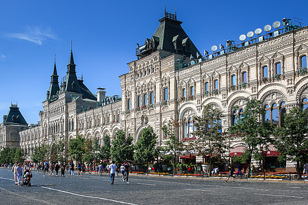 people walking in front of gray structure during daytime thumbnail