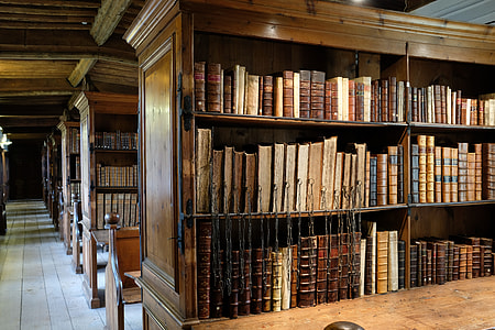 black wooden shelf filled with reading books in library thumbnail