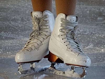 person wearing white figure skates thumbnail