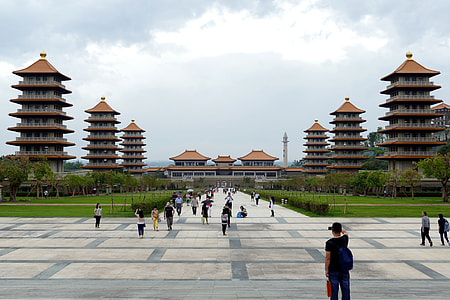 people in front of buildings under gray sky thumbnail