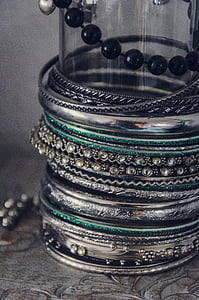 assorted bangles on clear glass cylinder thumbnail