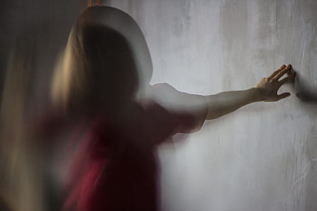 woman touching gray wall thumbnail