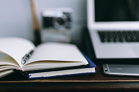 Elegant workspace with Macbook, iPhone, business cards and notebooks thumbnail