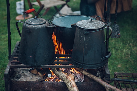 two black kettles on top of charcoal grill thumbnail