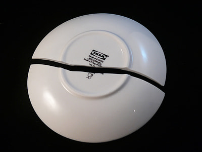 broken Ikea ceramic plate placed on black cloth thumbnail
