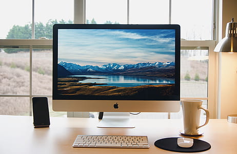 white iMac on white wooden table thumbnail
