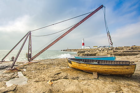 brown wooden canoe beside shore thumbnail