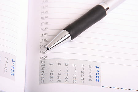 gray click pen on white line paper with calendar thumbnail