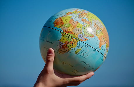 person holding teal globe thumbnail