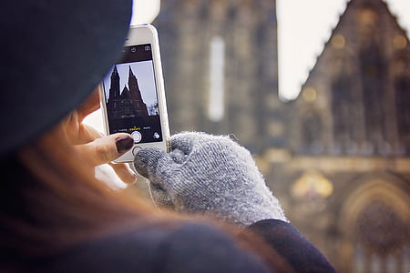person taking photo of cathedral thumbnail