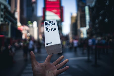 person holding about to hold white labeled box thumbnail